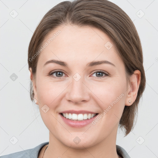 Joyful white young-adult female with medium  brown hair and grey eyes