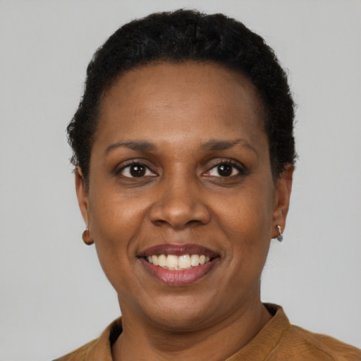 Joyful black adult female with short  brown hair and brown eyes