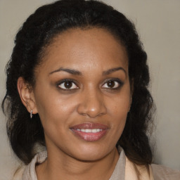 Joyful black young-adult female with medium  brown hair and brown eyes