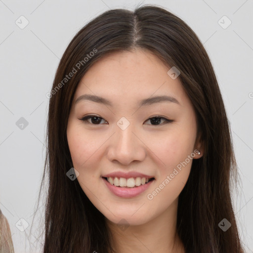 Joyful asian young-adult female with long  brown hair and brown eyes