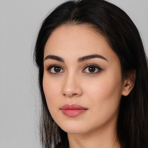 Joyful white young-adult female with long  black hair and brown eyes