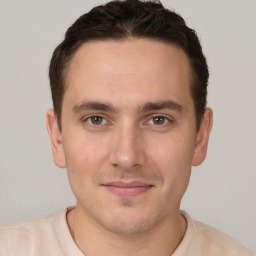 Joyful white young-adult male with short  brown hair and brown eyes