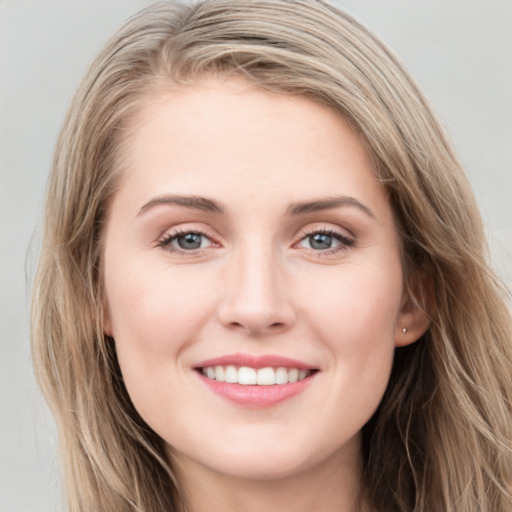 Joyful white young-adult female with long  brown hair and grey eyes