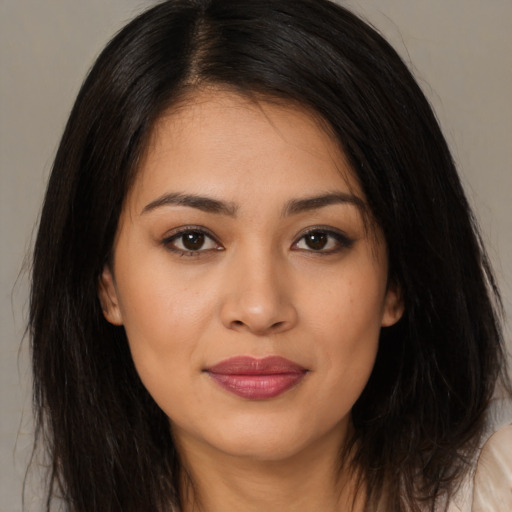 Joyful latino young-adult female with long  brown hair and brown eyes