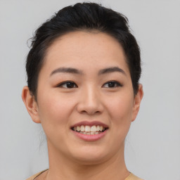 Joyful asian young-adult female with short  brown hair and brown eyes