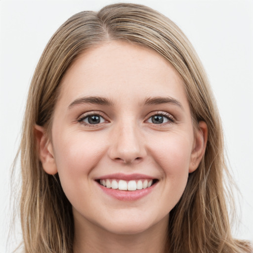 Joyful white young-adult female with long  brown hair and grey eyes