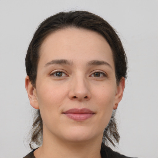 Joyful white young-adult female with medium  brown hair and brown eyes