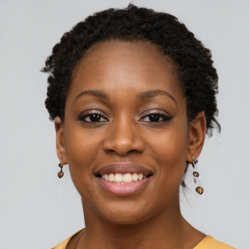 Joyful black young-adult female with short  brown hair and brown eyes