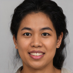 Joyful asian young-adult female with medium  brown hair and brown eyes