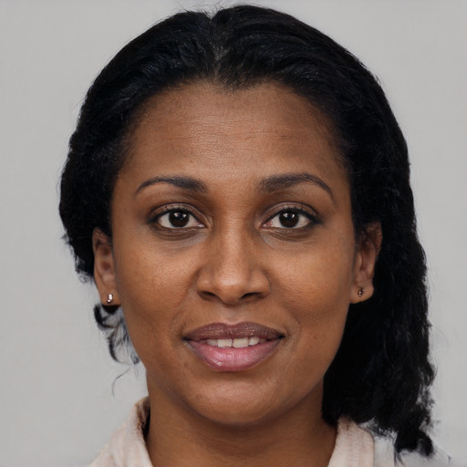 Joyful black adult female with medium  black hair and brown eyes