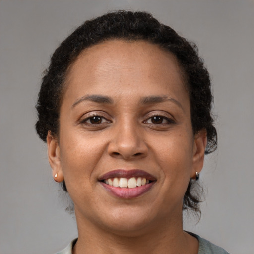 Joyful latino young-adult female with short  brown hair and brown eyes