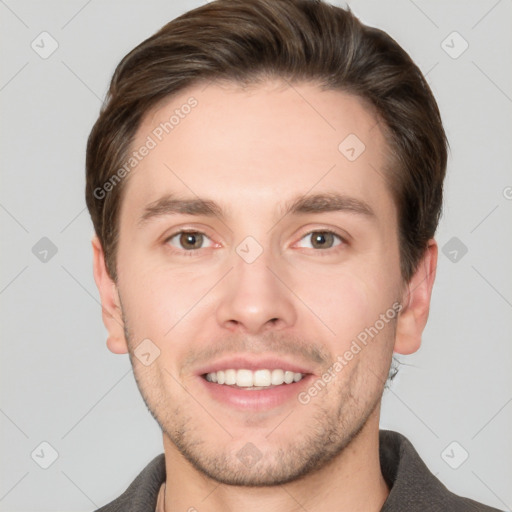 Joyful white young-adult male with short  brown hair and grey eyes