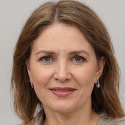 Joyful white adult female with medium  brown hair and grey eyes