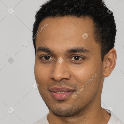 Joyful black young-adult male with short  black hair and brown eyes