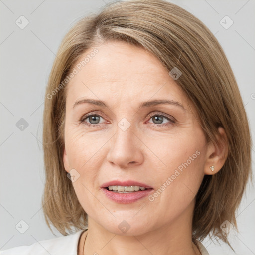 Joyful white adult female with medium  brown hair and grey eyes