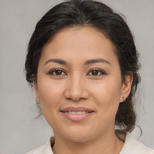 Joyful asian young-adult female with medium  brown hair and brown eyes