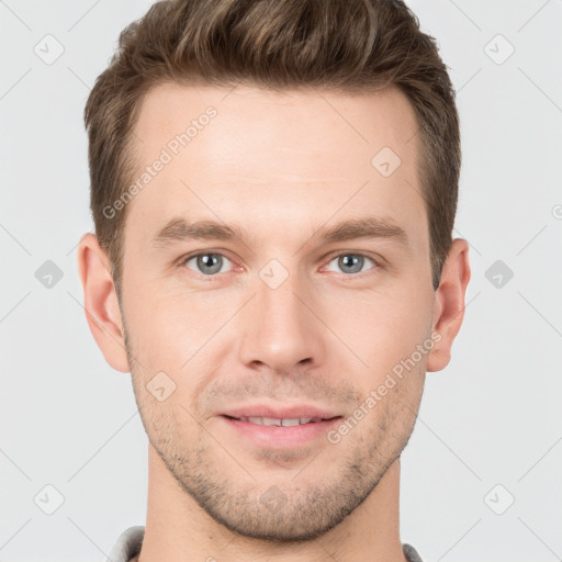 Joyful white young-adult male with short  brown hair and grey eyes