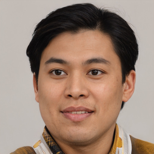Joyful asian young-adult male with short  brown hair and brown eyes