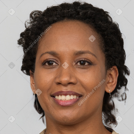 Joyful black adult female with medium  brown hair and brown eyes