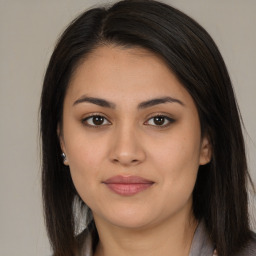 Joyful latino young-adult female with long  brown hair and brown eyes