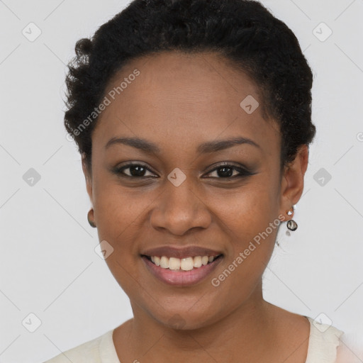 Joyful black young-adult female with short  black hair and brown eyes