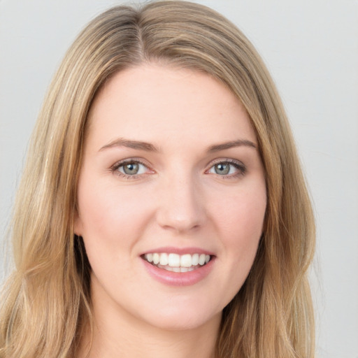 Joyful white young-adult female with long  brown hair and green eyes