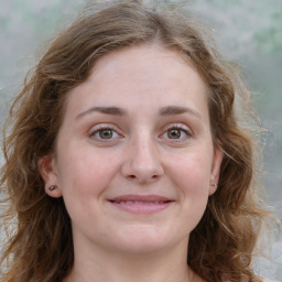 Joyful white young-adult female with long  brown hair and green eyes