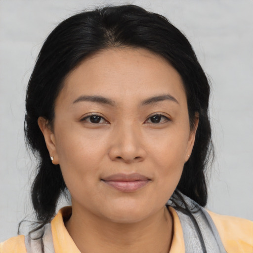 Joyful asian young-adult female with medium  black hair and brown eyes