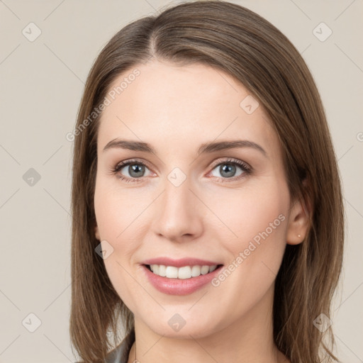 Joyful white young-adult female with long  brown hair and grey eyes