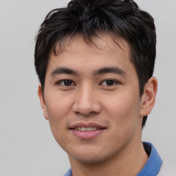 Joyful asian young-adult male with short  black hair and brown eyes