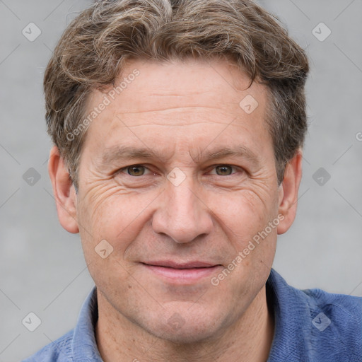 Joyful white adult male with short  brown hair and grey eyes