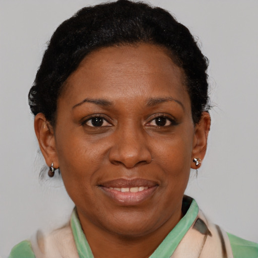 Joyful black adult female with short  brown hair and brown eyes