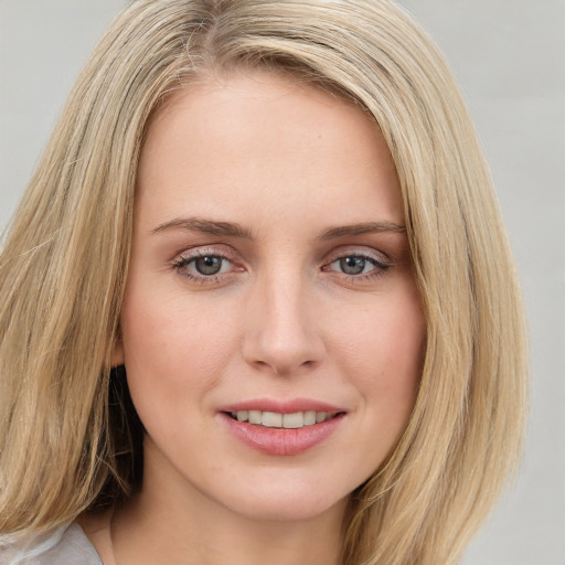 Joyful white young-adult female with long  brown hair and blue eyes