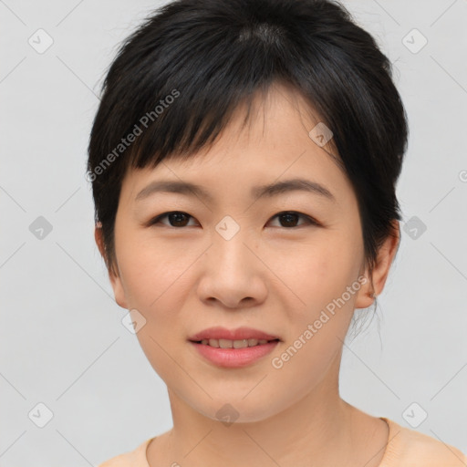 Joyful asian young-adult female with short  brown hair and brown eyes