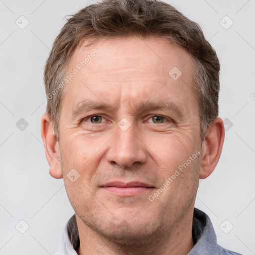 Joyful white adult male with short  brown hair and grey eyes