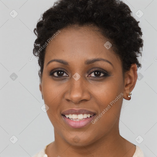 Joyful black young-adult female with short  brown hair and brown eyes