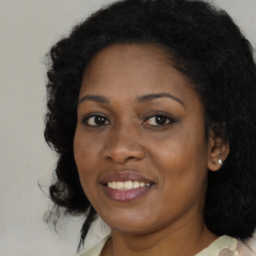 Joyful black young-adult female with medium  black hair and brown eyes