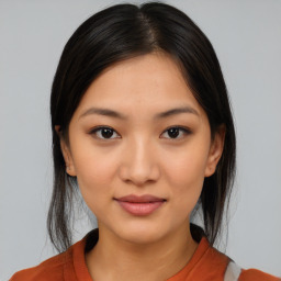 Joyful latino young-adult female with medium  brown hair and brown eyes