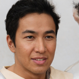 Joyful latino young-adult male with short  brown hair and brown eyes