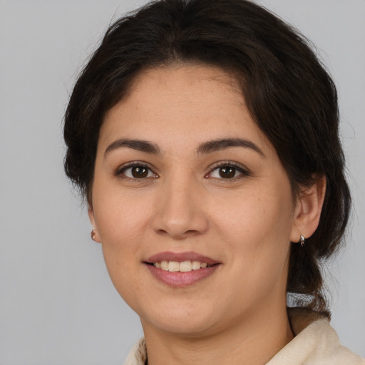 Joyful white young-adult female with medium  brown hair and brown eyes