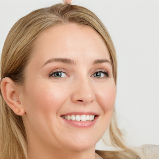 Joyful white young-adult female with long  brown hair and blue eyes