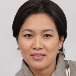 Joyful asian adult female with medium  brown hair and brown eyes