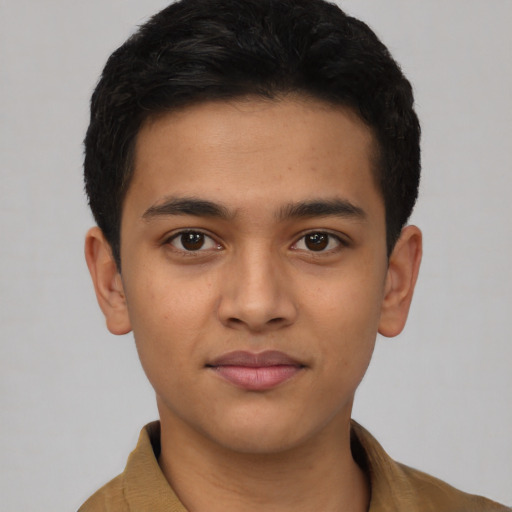 Joyful latino young-adult male with short  brown hair and brown eyes