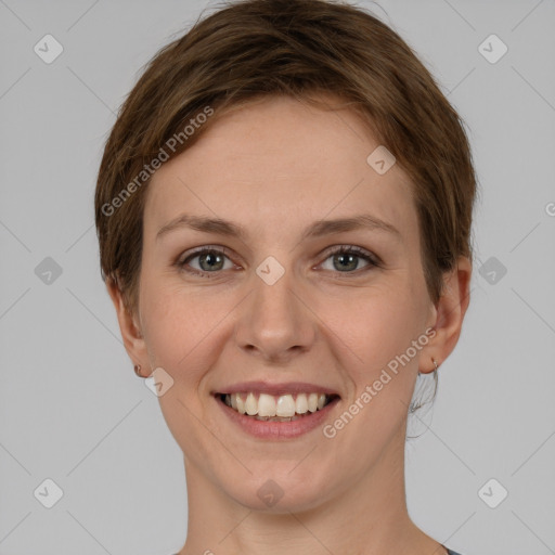 Joyful white young-adult female with short  brown hair and grey eyes