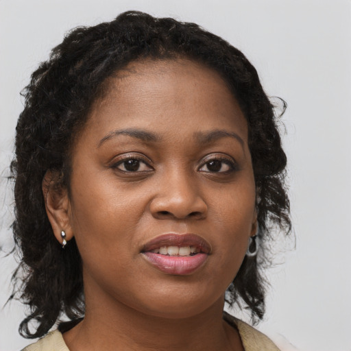 Joyful black young-adult female with medium  brown hair and brown eyes