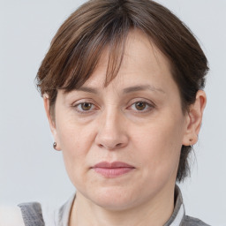 Joyful white adult female with medium  brown hair and grey eyes