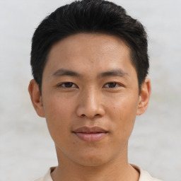 Joyful asian young-adult male with short  black hair and brown eyes