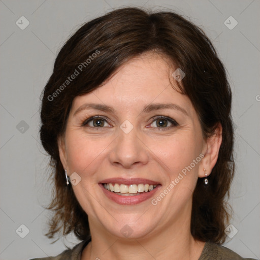 Joyful white adult female with medium  brown hair and green eyes