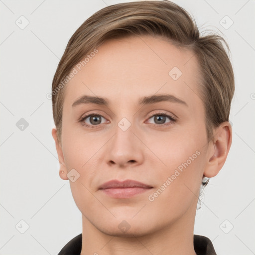 Joyful white young-adult female with short  brown hair and grey eyes