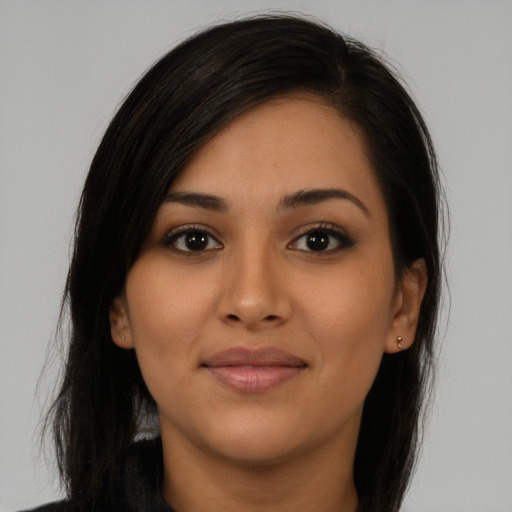 Joyful latino young-adult female with long  brown hair and brown eyes